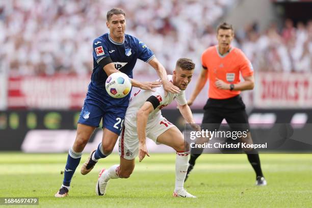 Robert Skov of Hoffenheim challenges Rasmus Carstensen of Koeln of Koeln during the Bundesliga match between 1. FC Köln and TSG Hoffenheim at...