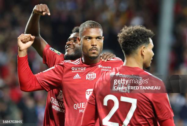 Brest's Beninese forward Steve Mounie celebrates with team mates after scoring a goal during the French L1 football match between Brest and Lyon at...