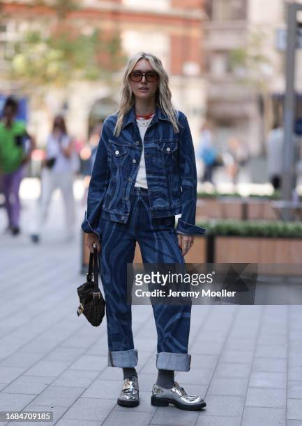 Polly Sayer was seen wearing shiny silver Prada loafer, a white top with red neck, brown transparent shades, a brown Fendi baguette bag, an oversized...
