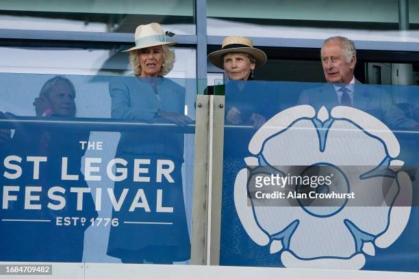 Queen Camilla Lady Halifax and King Charles III on the balcony watching The Betfred Park Stakes at Doncaster Racecourse on September 16, 2023 in...