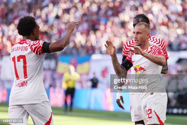 David Raum of RB Leipzig celebrates with Lois Openda after scoring his sides third goal during the Bundesliga match between RB Leipzig and FC...