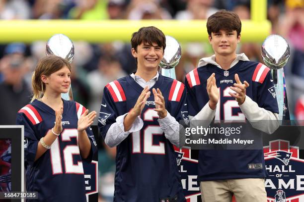 The children of former New England Patriots quarterback Tom Brady, Vivian, Benjamin, and Jack, look on during a ceremony honoring Brady at halftime...