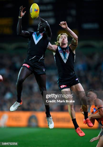 Aliir Aliir of Port Adelaide marks in front of Miles Bergman of Port Adelaide during the AFL Second Semi Final match between Port Adelaide Power and...