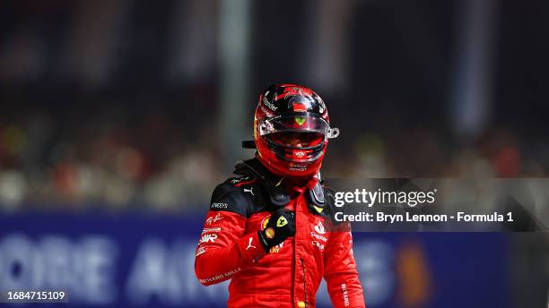 Pole position qualifier Carlos Sainz of Spain and Ferrari celebrates in parc ferme during qualifying ahead of the F1 Grand Prix of Singapore at...