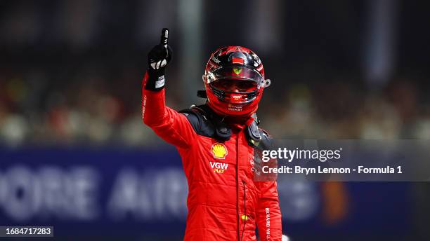 Pole position qualifier Carlos Sainz of Spain and Ferrari celebrates in parc ferme during qualifying ahead of the F1 Grand Prix of Singapore at...