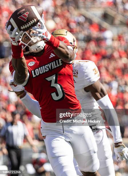 Kevin Coleman of the Louisville Cardinals reaches to catch a pass during the first half against the Boston College Eagles at Cardinal Stadium on...