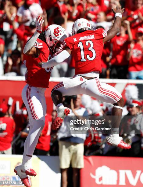 Landen King of the Utah Utes celebrates his touchdown catch with Nate Johnson during the first half of their game against the UCLA Bruins at...