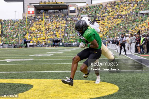 Wide receiver Troy Franklin of the Oregon Ducks catches a touchdown pass over cornerback Travis Jay of the Colorado Buffaloes during the first half...