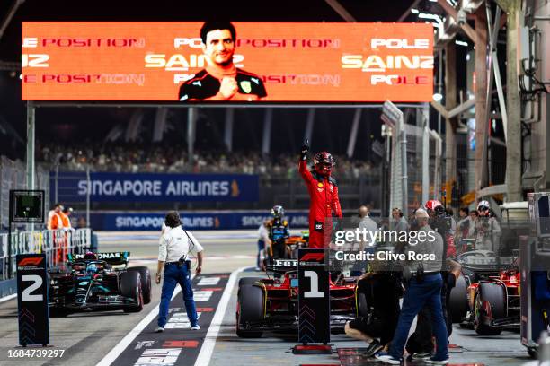 Pole position qualifier Carlos Sainz of Spain and Ferrari celebrates in parc ferme during qualifying ahead of the F1 Grand Prix of Singapore at...