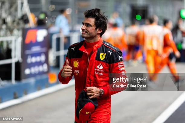 Pole position qualifier Carlos Sainz of Spain and Ferrari celebrates in parc ferme during qualifying ahead of the F1 Grand Prix of Singapore at...