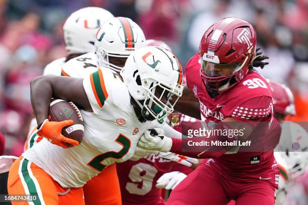 Donald Chaney Jr. #2 of the Miami Hurricanes runs the ball against Tra Thomas of the Temple Owls in the first half at Lincoln Financial Field on...
