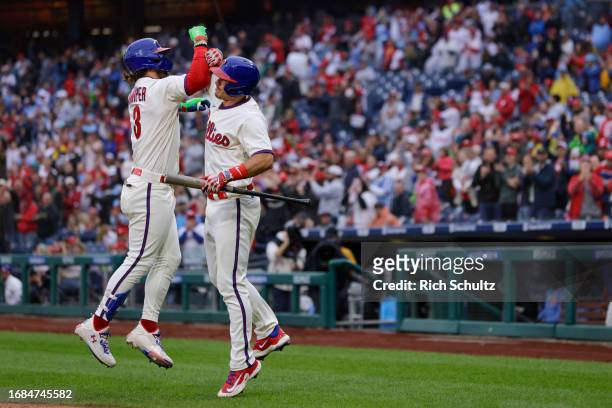 Bryce Harper of the Philadelphia Phillies celebrates his home run with J.T. Realmuto against the New York Mets during the second inning of a game at...