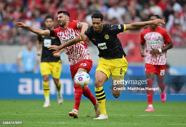Vincenzo Grifo of Sport-Club Freiburg and Felix Nmecha of Borussia Dortmund compete for the ball during the Bundesliga match between Sport-Club...
