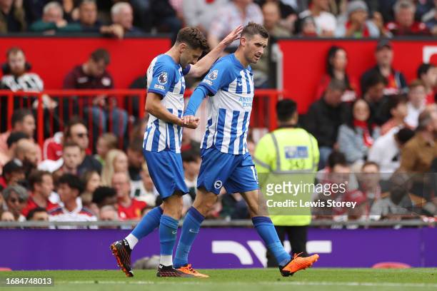 Pascal Gross of Brighton & Hove Albion celebrates with team mate Adam Lallana after scoring their sides second goal during the Premier League match...
