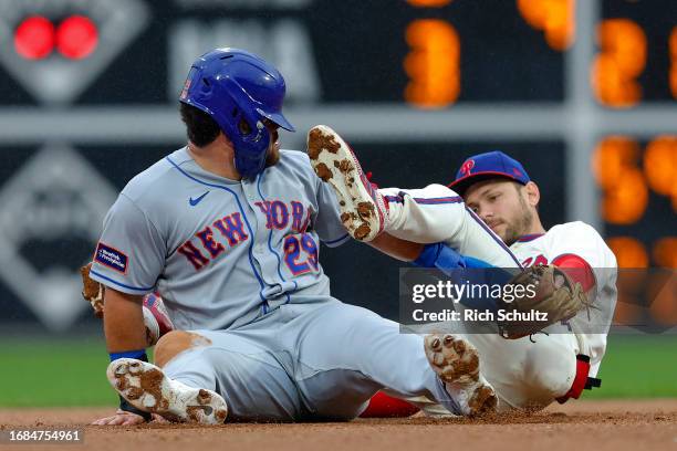 Stewart of the New York Mets is tagged out by second baseman Trea Turner of the Philadelphia Phillies after attempting to steal the base during the...