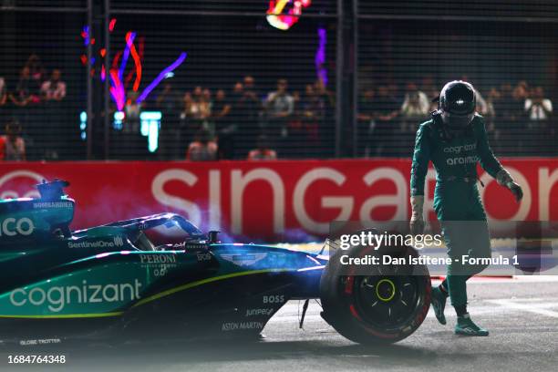 Lance Stroll of Canada and Aston Martin F1 Team climbs out of his car after crashing on track during qualifying ahead of the F1 Grand Prix of...
