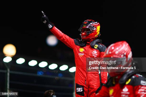 Pole position qualifier Carlos Sainz of Spain and Ferrari celebrates next to team-mate and third placed qualifier Charles Leclerc of Monaco and...