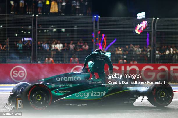 Lance Stroll of Canada and Aston Martin F1 Team climbs out of his car after crashing on track during qualifying ahead of the F1 Grand Prix of...