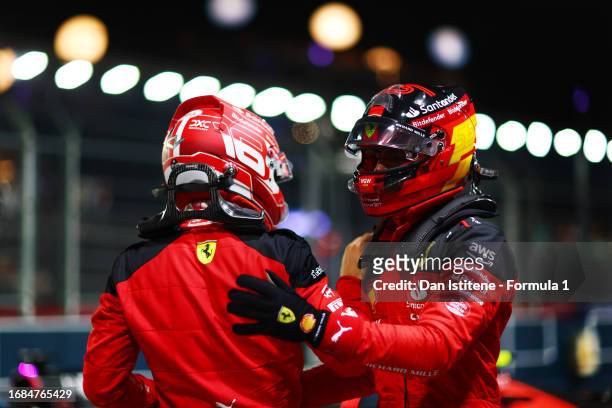Pole position qualifier Carlos Sainz of Spain and Ferrari celebrates with team-mate and third placed qualifier Charles Leclerc of Monaco and Ferrari...