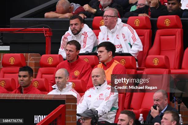 Harry Maguire of Manchester United looks on from the dugout during the Premier League match between Manchester United and Brighton & Hove Albion at...