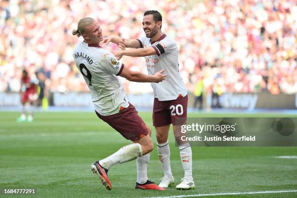 Erling Haaland of Manchester City celebrates with teammate Bernardo Silva after scoring the team's third goal during the Premier League match between...