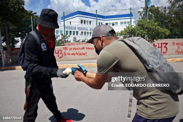 Students of the Raul Isidro Burgos Rural Normal School of Ayotzinapa throw firecrackers at the Attorney General's Office of the state of Guerrero, in...