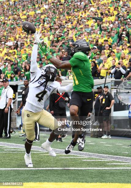 Oregon Ducks wide receiver Troy Franklin leaps over the outreached arm of Colorado Buffaloes corner Travis Jay for a touchdown during a PAC-12...