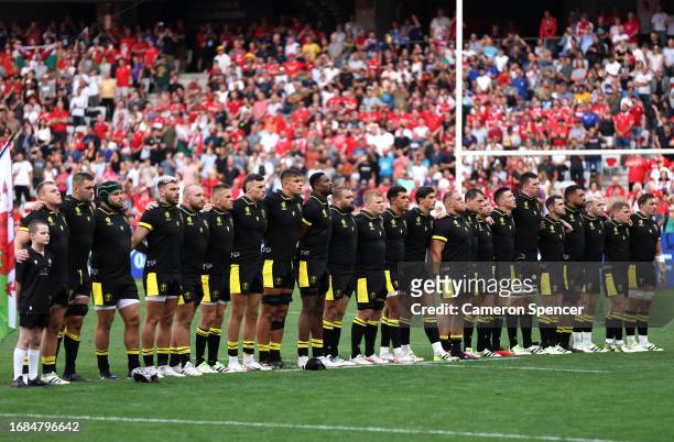 The players of Wales line up during the National Anthems prior to the Rugby World Cup France 2023 match between Wales and Portugal at Stade de Nice...