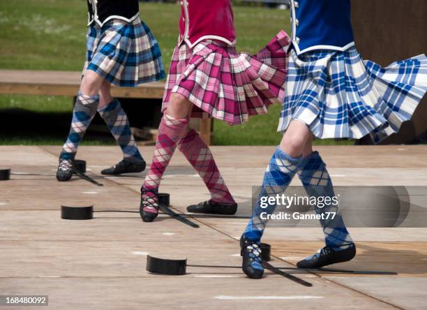 closeup of three pairs of feet of women scottish sword dancing - kilt stock pictures, royalty-free photos & images