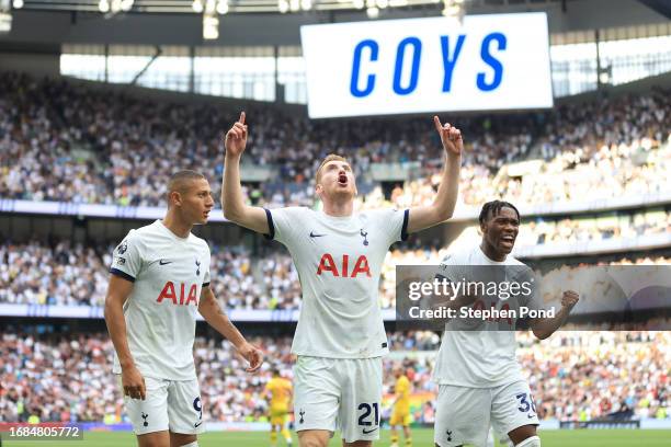 Dejan Kulusevski of Tottenham Hotspur celebrates with teammates Richarlison and Destiny Udogie after scoring the team's second goal during the...