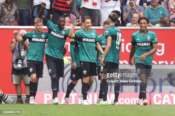 Serhou Guirassy of Stuttgart celebrates the team's third goal with teammates during the Bundesliga match between 1. FSV Mainz 05 and VfB Stuttgart at...