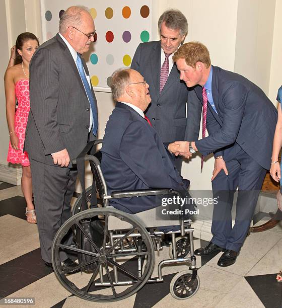 Prince Harry meets former senator Max Cleland as they attend a dinner at the British Ambassador's residence on May 9, 2013 in Washington, DC. HRH...