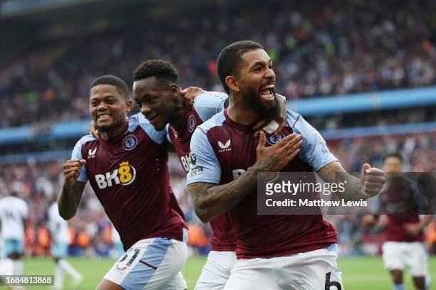 Douglas Luiz of Aston Villa celebrates with teammates Jhon Duran and Leon Bailey after scoring the team's second goal from the penalty spot during...