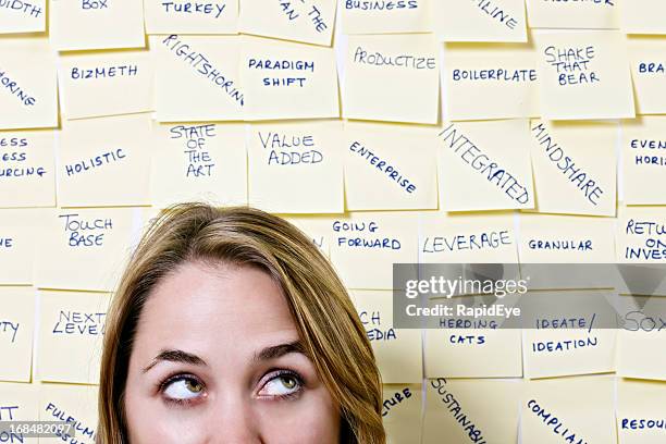 young woman rolls her eyes at mass of business buzzwords - excess data stock pictures, royalty-free photos & images