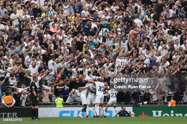 Dejan Kulusevski of Tottenham Hotspur celebrates in front of their fans with teammates after scoring the team's second goal during the Premier League...