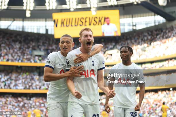 Dejan Kulusevski of Tottenham Hotspur celebrates with teammates Richarlison and Destiny Udogie after scoring the team's second goal during the...