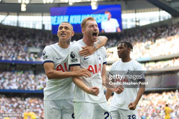 Dejan Kulusevski of Tottenham Hotspur celebrates with teammates Richarlison and Destiny Udogie after scoring the team's second goal during the...