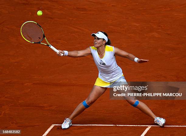 Spanish player Anabel Medina returns the ball to US player Serena Williams during their women's singles tennis match at the Madrid Masters at the...