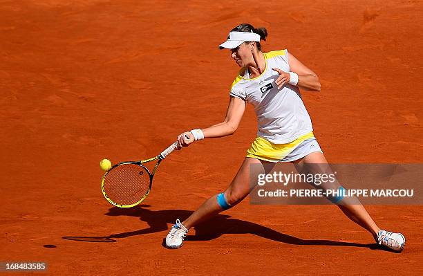Spanish player Anabel Medina returns the ball to US player Serena Williams during their women's singles tennis match at the Madrid Masters at the...