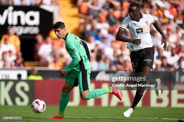 Alvaro Morata of Atletico de Madrid is challenged by Mouctar Diakhaby of Valencia CF during the LaLiga EA Sports match between Valencia CF and...
