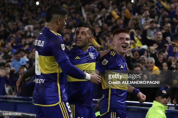 Boca Juniors' midfielder Lucas Janson celebrates with defender Marcos Rojo and defender Valentin Barco after scoring his team's first goal against...