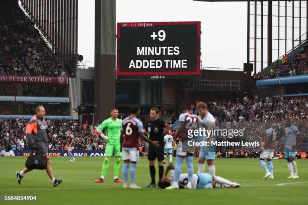 The LED board shows nine minutes added extra time during the Premier League match between Aston Villa and Crystal Palace at Villa Park on September...