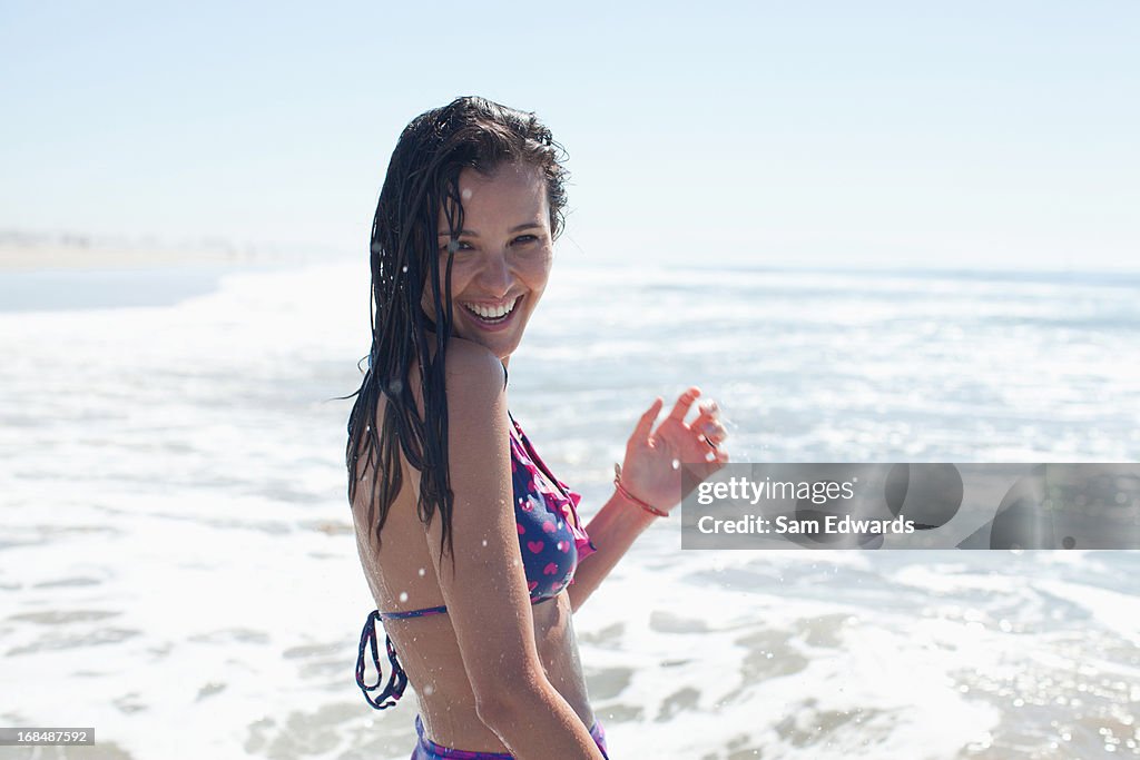 Woman playing in waves on beach