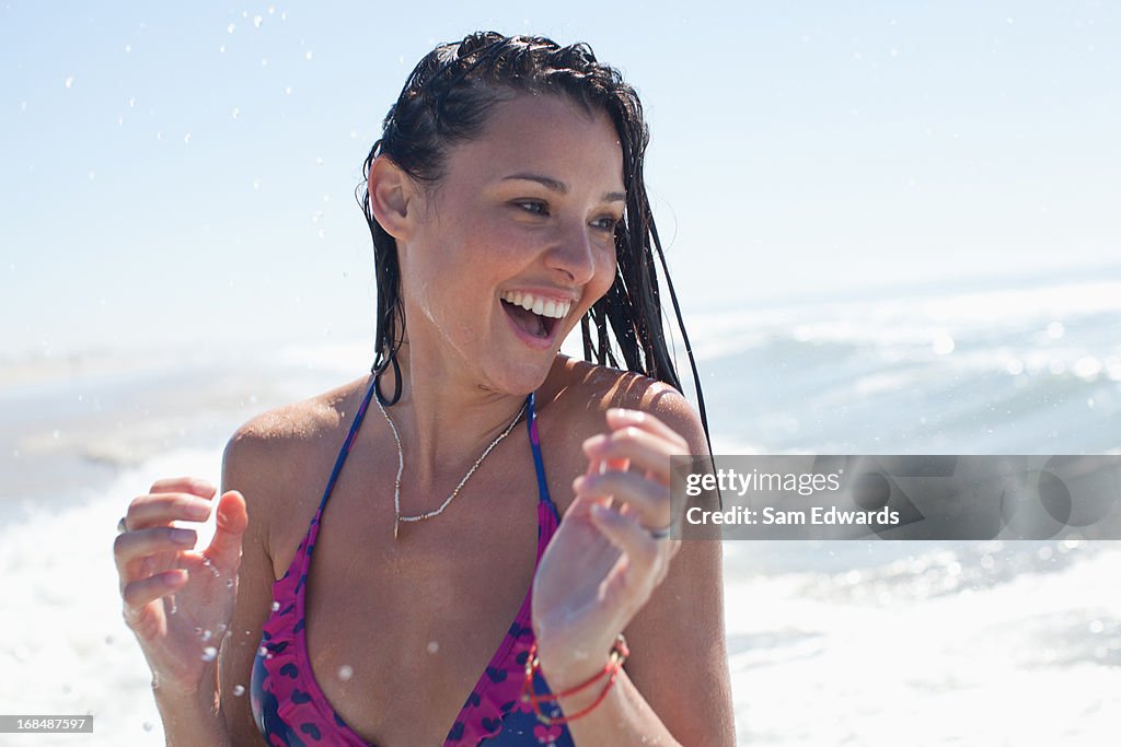 Woman playing in waves on beach