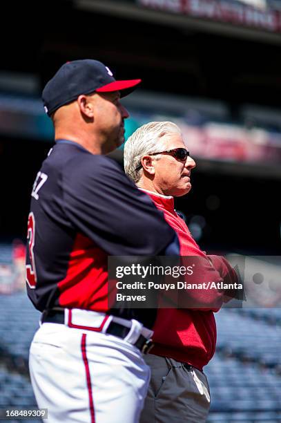 Manager Fredi Gonzalez and General Manager Frank Wren of the Atlanta Braves watch batting practice before the game against the Chicago Cubs at Turner...