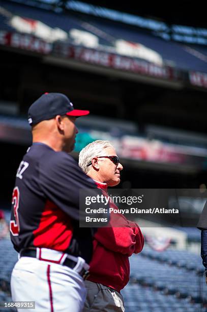 Manager Fredi Gonzalez and General Manager Frank Wren of the Atlanta Braves watch batting practice before the game against the Chicago Cubs at Turner...