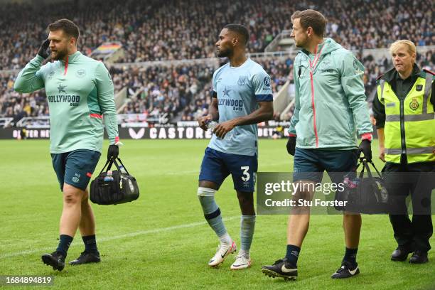 Rico Henry of Brentford leaves the pitch due to injury during the Premier League match between Newcastle United and Brentford FC at St. James Park on...