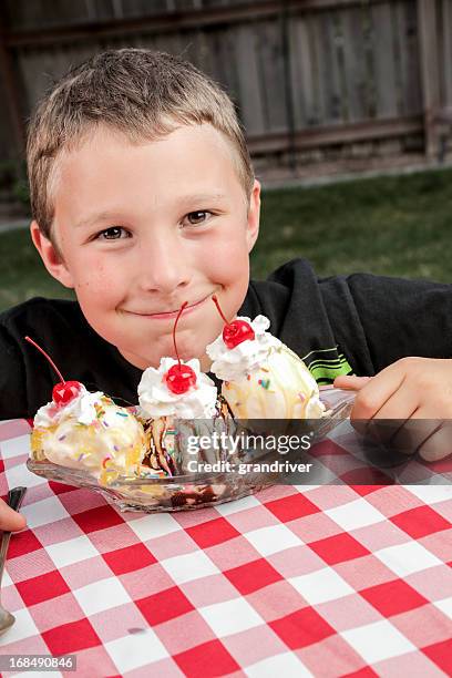 little boy with banana split - banana split stock pictures, royalty-free photos & images