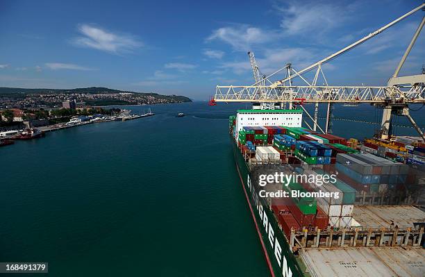 The container ship "Ever Ultra," operated by Evergreen Marine Corp Taiwan Ltd., stands beneath gantry cranes at the dockside in the port of Koper,...