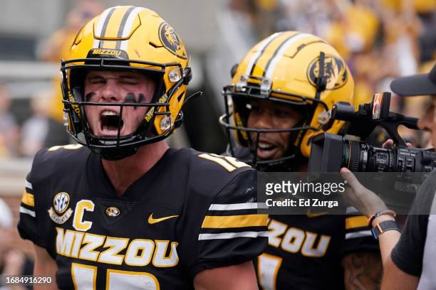 Quarterback Brady Cook of the Missouri Tigers celebrates his touchdown run with wide receiver Theo Wease Jr. #1 against the Kansas State Wildcats in...